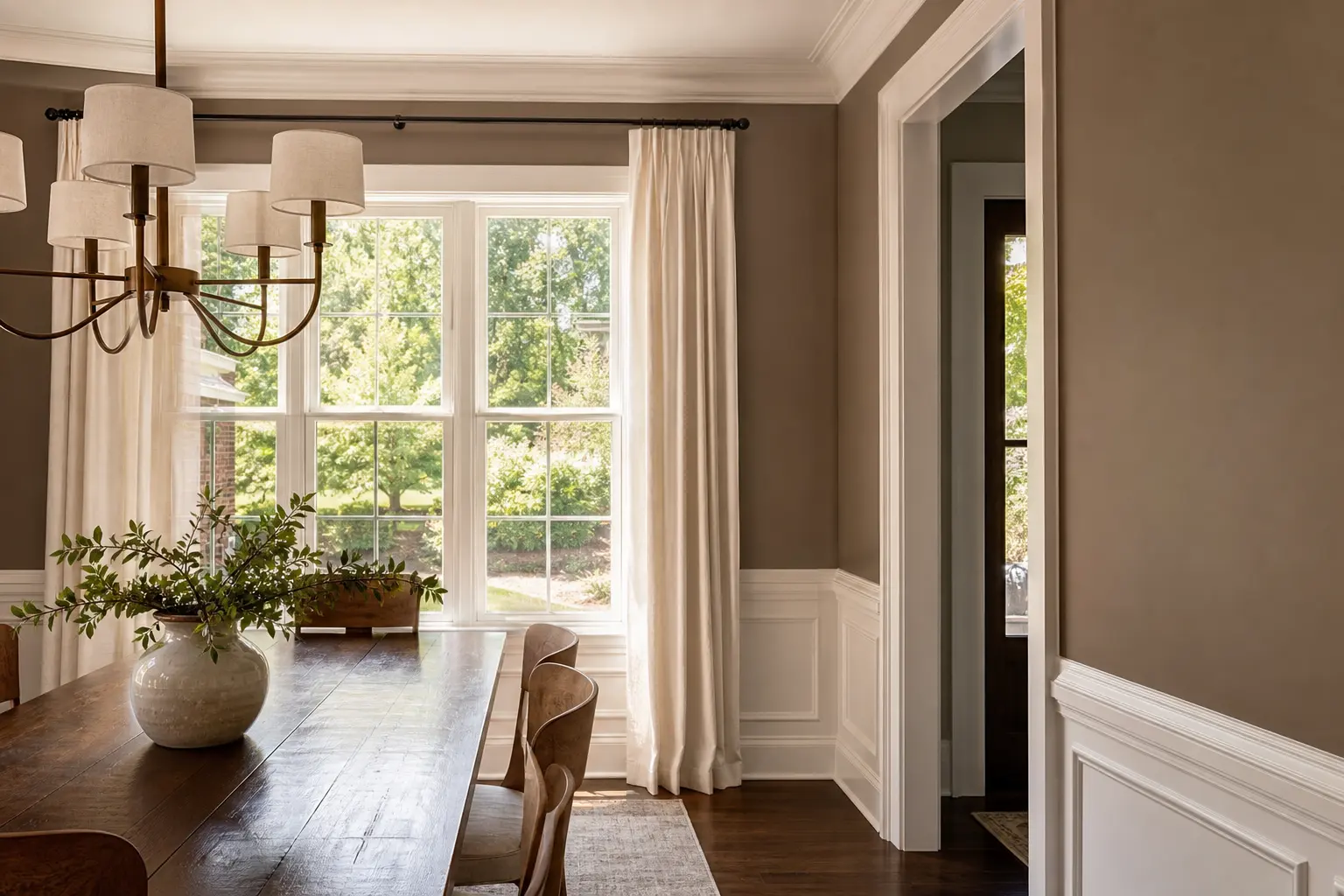 Dining room with warm taupe walls and crisp white molding